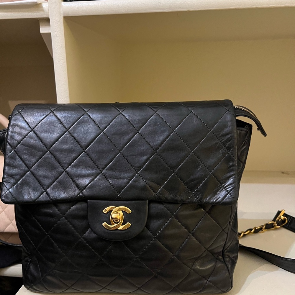 CHANEL Black Quilted Backpack with Gold Logo